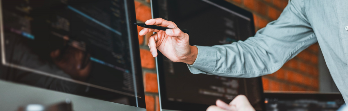 A man is using WebSocket Testing Tools to point at a computer screen.
